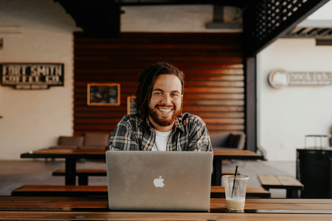 Happy person working on laptop